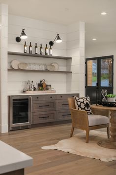 the kitchen is clean and ready to be used for dinner or entertaining purposes, as well as wine bottles on shelves