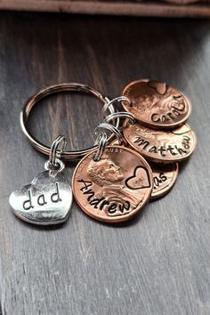 four different coins with the word dad on them are sitting on a table next to each other