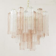 a chandelier made out of glass bottles hanging from a ceiling fixture in a room