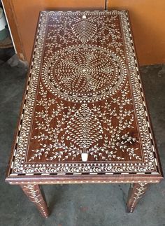 a wooden table with an intricate design on it