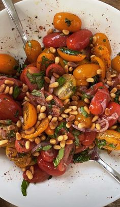 a white plate topped with tomatoes and beans