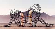 an advertisement for a festival in the desert, with two people riding on roller coasters