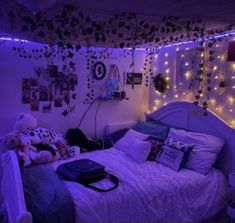 a bedroom with purple lights and stuffed animals on the bed