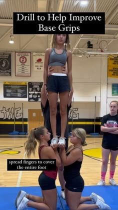 the girls are doing tricks on the basketball court while one girl is standing on top of another