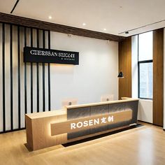 a reception area with wooden floors and white walls