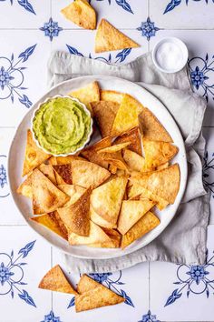 tortilla chips and guacamole on a plate