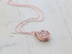 A high quality, genuine Druzy Quartz teardrop gilded in a rose gold titanium finish, is generously secured in my signature bezel wrapped style in 14k rose gold filled wire and suspended from delicate yet very sturdy 14k rose gold filled chain that I've hand finished for added durability. This necklace is a gorgeous piece that wears well alone or layered with other pieces. It would look fantastic with a hand stamped piece like this: https://www.etsy.com/listing/151477068/gold-bar-necklace-persona Rose Gold Wire Wrapped Necklace, Rose Gold Copper Jewelry For Anniversary, Anniversary Rose Gold Copper Jewelry, Anniversary Rose Gold Wire Wrapped Jewelry, Rose Gold Copper Round Necklace, Rose Gold Copper Round Necklaces, Rose Gold Round Necklaces, Geode Jewelry, Druzy Jewelry