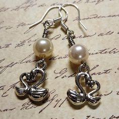 Swan Dangle Earrings with White Pearl.  Dangle approx 1.75".  Hypo-allergenic sterling silver ear wires. Nickel-free Silver Dangle Pearl Earrings, Silver Metal Drop Pearl Earrings, French Hook Pearl Drop Earrings For Gift, Hypoallergenic Metal Dangle Pearl Earrings, Hypoallergenic Dangle Pearl Earrings, Pierced Metal Pearl Earrings For Anniversary, Nickel-free Silver Drop Pearl Earrings, Gift Pearl Earrings With Metal Ear Wire, Sterling Silver Dangle Pearl Earrings For Pierced Ears