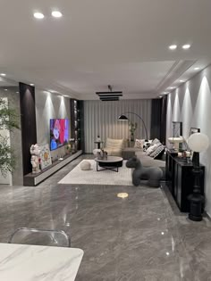 a living room filled with furniture and a flat screen tv mounted on the wall above it