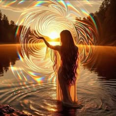 a woman is standing in the water with her arms out and spinning circles around her