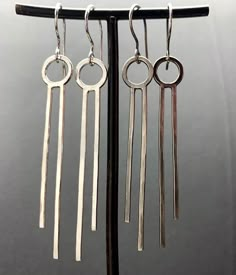 Super lightweight, super stylish. Made from 16g sterling silver wire. Hammered and stamped on back: handwrought, sterling, stelzer. These look great with simple, chic clothes and collared shirts. So crisp and clean. Available in both finishes: the shiny/bright finish is on the left side in photos and the darkened/oxidized is on the right. Please specify which you prefer in the note to seller during checkout. They measure 2-3/4” from the top of the hook. The drop is 2-1/4”. Soldering Projects, Portsmouth Nh, Collared Shirts, Hammered Earrings, Simple Chic, Jewellery Ideas, Metal Work, Silver Earrings Dangle, Chic Clothes