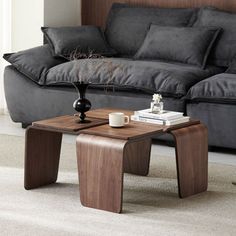 a living room with a couch, coffee table and two end tables in front of it