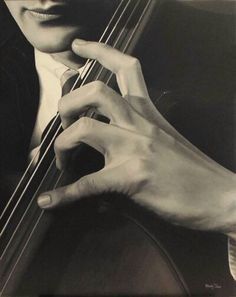 a black and white photo of a person holding a violin