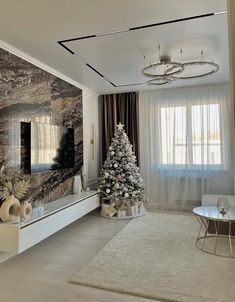 a living room with a christmas tree in the center and decorations on the wall behind it