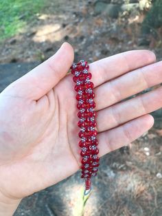 Opaque Red handmade lentil bracelet. I stitched this bracelet using a needle and fireline beading thread. It is made with red two hole lentil beads and size 15 seed beads. This bracelet is 7 and 3/4 inches long and 1/2 an inch wide. Metal free, and perfect for people with allergies to copper, iron, gold, or silver! :)   Materials *czech beads *fireline  *seed beads (size 15) *two hole lentil beads  Feel free to message me with any questions about this product Red Hand-strung Beaded Bracelets, Red Bohemian Crystal Bracelet With Round Beads, Bohemian Red Crystal Bracelet With Round Beads, Handmade Red Beads For Friendship, Handmade Red Bohemian Crystal Bracelet, Handmade Bohemian Red Crystal Bracelet, Handmade Adjustable Beaded Bracelets With Oval Beads, Red Beaded Bracelets For Crafting, Handmade Red Beads For Crafting