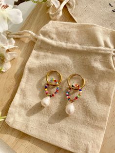 These are unusual, colorful boho earrings with a freshwater pearl. They are waterproof and nickel-free. The price is for 1 pair!🤍 Beautiful and eye-catching earrings in boho/hippie style. They enchant with beautiful and colorful beads that are a total eye-catcher. 💕 You can combine them with simple but also with eye-catching outfits. They are guaranteed to enhance any outfit! 🥰 Material: The material is made of gold-plated stainless steel and is therefore rust and nickel free. The lightweight Diy Hippie Earrings, Golden Hoop Earrings, Boho Hippie Style, Golden Hoops, Earrings Golden, Bead Charms Diy, Hippie Earrings, Colorful Earrings, Girly Jewelry