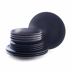 black dinner plates stacked on top of each other in front of a white background,