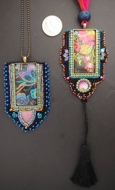 two pieces of beaded jewelry are hanging on a wall next to a coin with a tassel