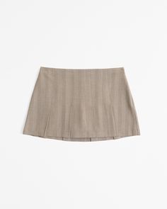 Mid rise mini skort in our herringbone fabric, featuring all-over pleating details, shorts lining for comfort and side zipper for a secure fit. Fitted Beige Bottoms With Pleated Hem, Fitted Beige Bottoms With Accordion Pleats, Beige Fitted Short Skort, Fitted Beige Short Skort, Classic Mini Skirt Skort For Summer, Classic Mini Skort For Summer, Herringbone Fabric, Women's Bottoms, Suit Accessories