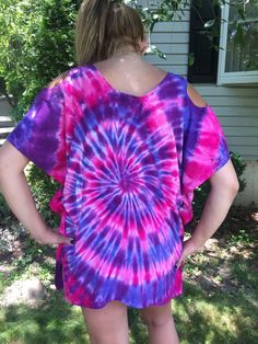 "This color combination poncho is new to my store just now, Summer 2016. This shirt is so neat, so pretty and can even be used as a bathing suit cover up. This is my beautiful niece modeling it. Some may call it a poncho. It is a 100% rayon lightweight, discreet exposed shoulder (peek a boo) shirt. What an incredible shirt for hot summer nights or anytime for that matter. Wear with leggings or even jeans; it will look fantastic. This particular shirt, I dyed in lilac, purple, hot pink and dragon Oversized Purple T-shirt For Summer, Multicolor Bohemian T-shirt For Beach, Summer Bohemian T-shirt For Vacation, Bohemian Summer T-shirt For Vacation, Bohemian Summer Vacation T-shirt, Summer Vacation Bohemian T-shirt, Fun Summer Festival T-shirt, Flowy Multicolor Cotton Tops, Bohemian T-shirt For Spring Beach Days