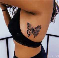 a woman's stomach with a butterfly tattoo on her side and the bottom part of her body