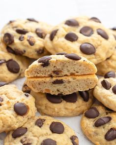 chocolate chip cookies stacked on top of each other with one cookie cut in half to show the inside