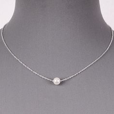 Floating Single White Pearl Dainty Silver Chain Necklace Delicate June Birthstone Pendant Simple Minimalist Jewelry This beautiful pearl and silver necklace is stunning! Simple and gorgeous, the look of this delicate silver chain accented by a single round 7 mm pearl is both classic and on trend. You can wear this pearl floating on dainty chain for any occasion. Also it`s wonderful necklace for Bride or Bridesmaids. Length: 16 inches with 3 inch extension Pearl: 6mm Closure: Lobster claw Weight: Pearl And Silver Necklace, Pearl Necklace Silver Chain, Minimalist Jewelry Silver, Silver Necklace Simple, Single Pearl Necklace, Single Pearl, Silver Pearl Necklace, Costume Fashion, Pearl Necklaces