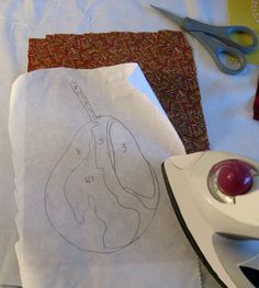 a piece of paper with a drawing on it next to a iron and some scissors