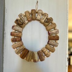 a wreath made out of wine corks hanging on a door