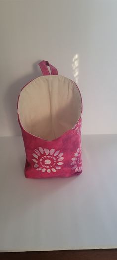 a pink and white bag sitting on top of a table