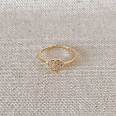 18k Gold Filled Dainty Cubic Zirconia Heart Ring Metal: 18k Gold Filled Available in sizes: 5,6,7 and 8 Hypoallergenic jewelry - Nickel Free Water-resistant Rigorously manufactured under CA Prop 65 and EU standards Handcrafted in Brazil Gold Heart Ring With Diamond Accents Cubic Zirconia, Yellow Gold Heart Ring With Cubic Zirconia, Gold Heart Cut Cubic Zirconia Heart Ring, Dainty Gold Diamond Heart Ring, Gold Heart Diamond Ring With Vs Clarity, Gold Diamond Ring With Vs Clarity In Heart Shape, Dainty Gold Heart Diamond Ring, Valentine's Day Gold Heart Diamond Ring, Gold Heart-shaped Diamond Ring For Valentine's Day