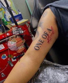 a man with a tattoo on his arm that reads, one day at a time