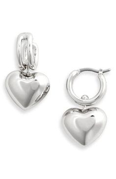 High-polished drop earrings have an innovative suspension design allowing the luminous heart to glide back and forth between the rails for subtle movement. 1/2" hoop diameter; 1" drop Snap-post closure 14k-gold plate Imported Elegant Sterling Silver Huggie Earrings With Heart Charm, Elegant Dangle Huggie Earrings With Heart Charm, Silver Elegant Huggie Earrings With Heart Charm, Elegant Silver Huggie Earrings With Heart Charm, Valentine's Day Polished Finish Earrings, Elegant Dangle Huggie Earrings For Valentine's Day, Elegant Silver Huggie Heart Earrings, Elegant Double Heart Huggie Earrings With Heart Charm, Modern Heart Earrings For Anniversary