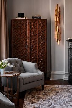 a living room filled with furniture and a fire place next to a wall mounted clock