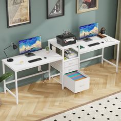 two computer desks sitting on top of a hard wood floor next to each other