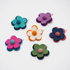 A lovely flower hair clip, hand made from merino wool, that brings a pop of colour to any hairstyle. A quirky and cute way to style your hair, our flower hair clip keep your hair secure whilst also looking great.  All of our felt products are made by one of the leading Fair Trade felt makers in Nepal. Instead of weaving the wool, felt is created by applying heat, moisture and pressure to the wool to entangle the fibres and create a beautiful end result. The felt is coloured using only natural dy Personalised Photo Albums, Felt Hair Bows, Photo Album Journal, Felt Products, Leather Photo Albums, School Hair, Card Holder Purse, Felt Garland, Flower Hair Clip