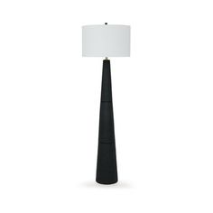 a tall black lamp with a white shade on the base and a light in front of it