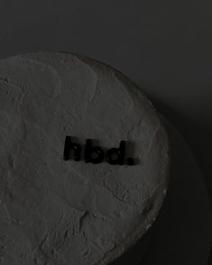 a white cake with the word bdn spelled out on it's side