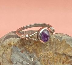 Sterling Silver vintage ring with an oval, bezel set bandedAmethyst cabochon in shades of purple. This pretty, boho style solid silver ring has split shoulders and is stamped SIL for silver.  Good vintage condition  UK size N, US size 7  The stone measures 7 x 5 mm Weight 2g Please study the photographs where I try to show as much detail as possible. Any damage or obvious imperfections will be clearly stated. I offer FREE SHIPPING on all of my listings so the price you see is the price you pay! Vintage Oval Amethyst Birthstone Ring, Oval Amethyst Cabochon Ring, Vintage Amethyst Oval Cabochon Ring, Collectible Oval Cabochon Amethyst Ring, Classic Oval Cabochon Amethyst Jewelry, Oval Cabochon Amethyst Ring Gift, Spiritual Oval Amethyst Ring With Stone Setting, Cabochon Amethyst Ring Gift, Classic Silver Amethyst Ring Oval Cabochon