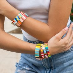 What can be more fun that these colorful, stackable, elastic bracelets? Each tile is handmade with an oil dripping technique and then beautifully arranged to complete the design. Wear just one or stack them all and see all the heads turn. These bracelets are that gift everyone loves to receive. - Care Instructions: Avoid contact with water, lotion, and perfume. Clean gently with a polishing cloth. Product Specifications: - Adds a touch of color to your wrist - Handcrafted with love and care - Ea Playful Multicolor Stackable Bracelets, Trendy Multicolor Stackable Stretch Bracelet, Casual Multicolor Stackable Friendship Bracelets, Multicolor Stacked Bracelets As Gift, Multicolor Stackable Stretch Bracelet As Gift, Tile Bracelet, Gold Tile, Elastic Bracelets, Unique Tile