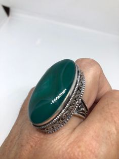 Large green agate Ornate German Silver Vintage ring, does not tarnish Size 9 can be re sized, my jeweler charges a $10 - $15 fee All rings are shipped in a nice gift box. Check out our over a THOUSAND great reviews Engraving is $4 per letter and is not always perfect depending on the piece. It can take a few days if the jeweler is busy. This is payable to Paypal Judithsltd@gmail.com Spiritual Green Ring With Large Stone, Handmade Green Oval Crystal Ring, Green Oval Cabochon Ring For Gift, Handmade Green Oval Cabochon Ring, Green Oval Crystal Ring With Natural Stones, Bohemian Green Oval Cabochon Ring, Green Spiritual Rings For Jewelry Making, Adjustable Green Rings With Large Stone, Adjustable Green Ring With Large Stone