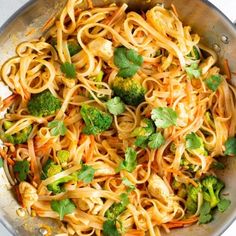 broccoli, carrots and noodles in a pan