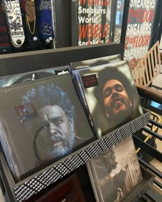 several records are stacked on top of each other in front of a store display case