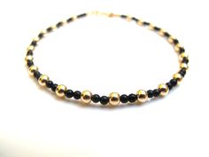 Luxurious bracelet handmade solid 14 k yellow gold beads and black onyx beads  UNISEX   Threaded on 24 k gold plated stainless steel wire   14 K solid yellow Gold beads solid gold not plated 3 mm  Genuine non synthetic 2 mm black onyx beads  14 k solid gold end caps  14 k solid spring closure * Casual  * By Symbolina Bracelet comes in an elegant box Thanks for visiting symbolina store Have a lucky day Item: SY 1220 To share with your friends pin it on Pinterest. Click Like to show them on Facebo Elegant Yellow Gold Bracelets With Black Beads, Elegant Yellow Gold Bracelet With Black Beads, Elegant Black Jewelry With Gold Beads, Adjustable Gold Onyx Bracelet, Adjustable Gold Onyx Bracelets, Minimalist Beaded Onyx Jewelry, Classic Gold Onyx Jewelry, Minimalist Onyx Beaded Jewelry, Adjustable Gold Bracelet With Polished Beads