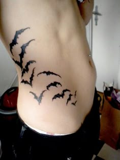 a woman's stomach with bats on it