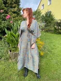 Our handmade  kaftan is made of high quality soft Indian silk blend printed with beautiful abstract and floral print. This garment is perfect for any type of occasion. From day on the beach, to an evening dinner or even a cocktail party, Thanks to its strap it is possible to adapt it to any type of body and size. It can be worn  unfastened  as a tunic or by tightening the belt it takes shape on your body becoming a stunning dress.  The best choice to impress, you'll look divinely beautiful in this boho chic dress. A must have for every bohemian queen. Length 51 inches 70% Silk 30% Viscose ONE SIZE FITS ALL! Bohemian V-neck Printed Kaftan, Printed Tunic Maxi Dress For Festivals, Festival Tunic Maxi Dress Printed, Hippie Dresses With Boho Print And Kimono Sleeves, Bohemian Maxi Kimono For Festivals, Bohemian Kaftan With Boho Print And Kimono Sleeves, Bohemian Silk Summer Tunic, Casual Silk Kaftan For The Beach, Bohemian Silk V-neck Maxi Dress