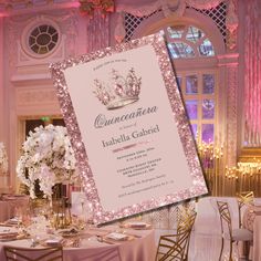 a pink and gold wedding reception at a fancy venue with floral centerpieces on the table