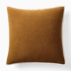 a brown pillow on a white wall