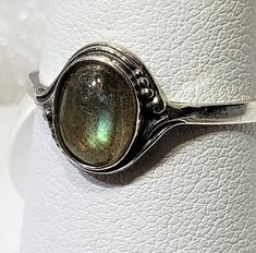 Magical Natural labradorite silver 925 mark ring szs 4-12 cabochon stone size 6 x 8 mm gift box included A semi-precious stone is also known as a gem or gemstone (also a jewel, a gem, a precious stone), which is a portion of mineral, which, in refined and cut form, is used to create jewelry or other embellishments. There are also organic resources or precise rocks that are not minerals (for example jet or amber) that are also used for jewelry and would also be considered to be gemstones, as well Collectible Oval Cabochon Moonstone Ring, Handmade Oval Dainty Jewelry, Vintage Oval Cabochon Moonstone Jewelry, Oval Cabochon Moonstone Jewelry, Handmade Adjustable Ring With Round Stone, Handmade Adjustable Rings With Round Stone, Dainty Oval Cabochon Gemstone Rings, Oval Cabochon Rings For May Birthstone, Dainty Oval Cabochon Ring