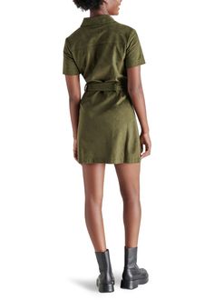 Experience the feel of luxurious faux suede in the Steve Madden Jolene Dress. This olive green mini dress features a tie at the waist, providing a sleek silhouette perfect for any occasion—from a girls night out to holiday festivities. Elevate your look with knee-high boots for a stylish fall look. Fit: True to Size Model is wearing a size S Imitation Leather: 100% Polyurethane Button closure all the way down If you would like to see more photos or speak with one of our stylists with any further Faux Suede Fabric, Loungewear Jumpsuit, Green Mini Dress, Midi Maxi Dress, Love Is Free, Plus Size Swimwear, Shirtdress, Long Blouse, Fall Looks